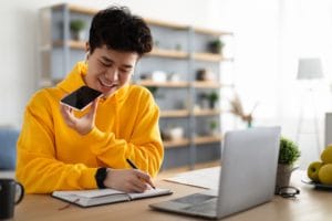 asian-guy-using-voice-assistant-on-cellphone-GMPUZ4B (1)