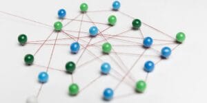 blue green pushpins with thread route map 1 1