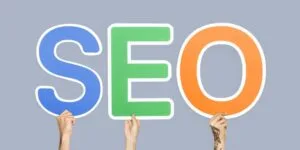 hands holding up colorful letters forming abbreviation seo 1