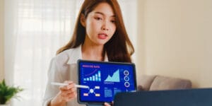 asia businesswoman using laptop tablet presentation colleagues about plan video call while working from home living room self isolation social distancing quarantine coronavirus 2